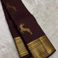 Full view of deep brown Kancheepuram silk with individual buttas and distinctive leaping deer motif