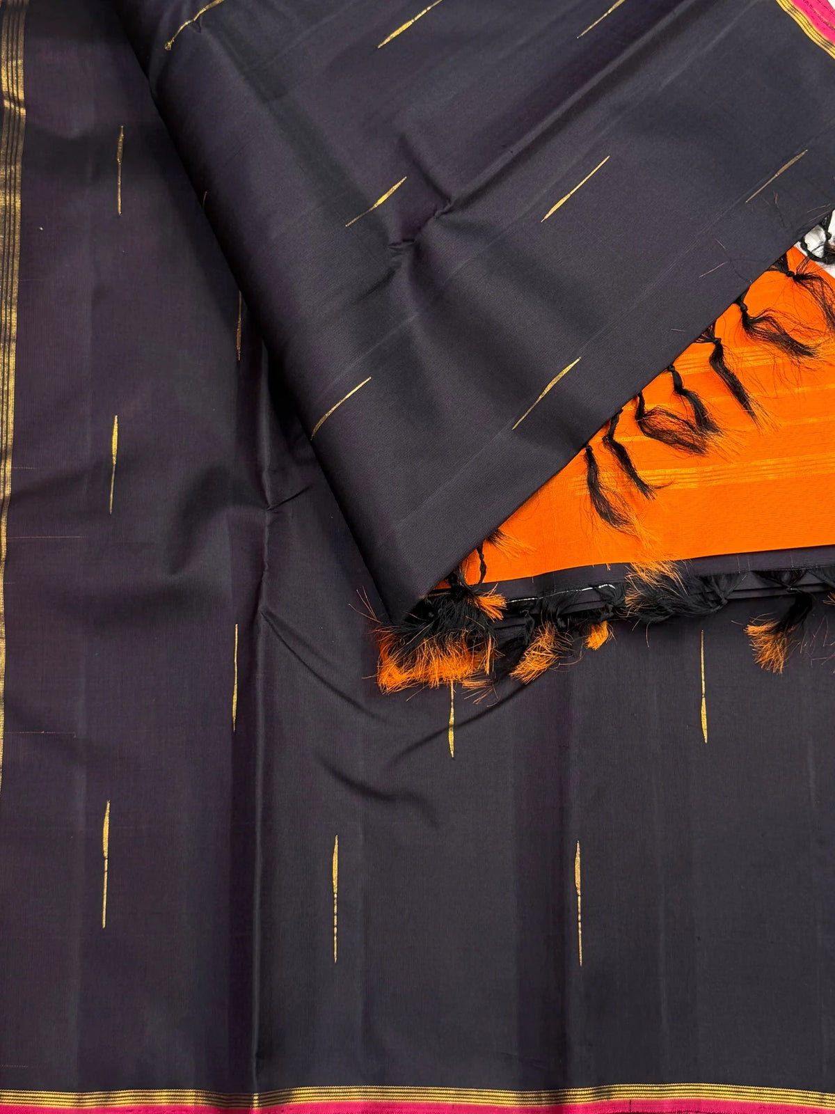 Thirushnam Orange silk pallu with fine gold horizontal stripes contrasting with the deep brown saree body