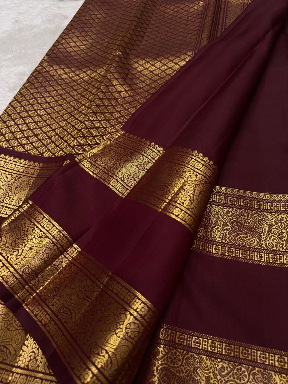 Draped Deep Burgundy silk body showing handwoven Mail buttas arranged in a precise repeating array grid