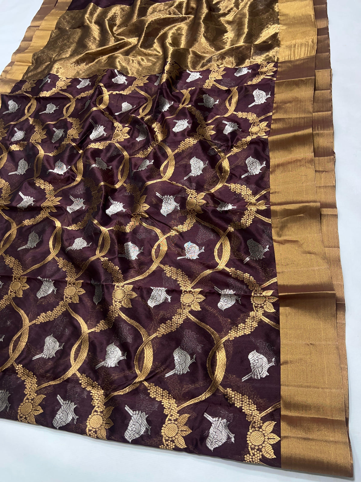 Deep Cocoa Brown Pattu Silk Chanderi saree with gold floral-vine lattice, silver bird motifs and broad antique-gold border and pallu.