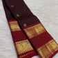 Deep cocoa pure silk body weave close-up with gold zari floral butta, Kanchipuram saree