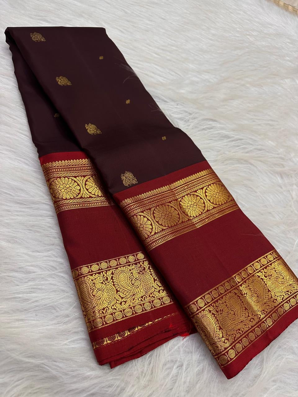 Deep cocoa pure silk body weave close-up with gold zari floral butta, Kanchipuram saree