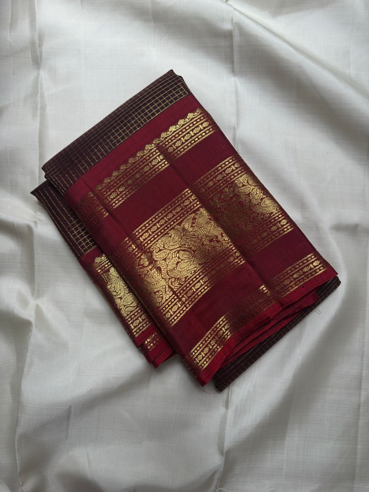 Deep Coffee Brown Kanchipuram body with fine gold Zari Kattam, petite buttas and rich red border.