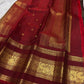 Folded Coffee Brown and Arakku Red Pure Silk Kanchipuram saree showing intricate gold zari border and pallu.