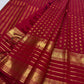 Close view of Vermilion Pinkish Red silk with alternating rounded and ornamental gold zari buttas
