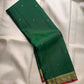 Deep Emerald Green handwoven pure silk Kanjivaram Butta saree with antique-gold zari buttas.