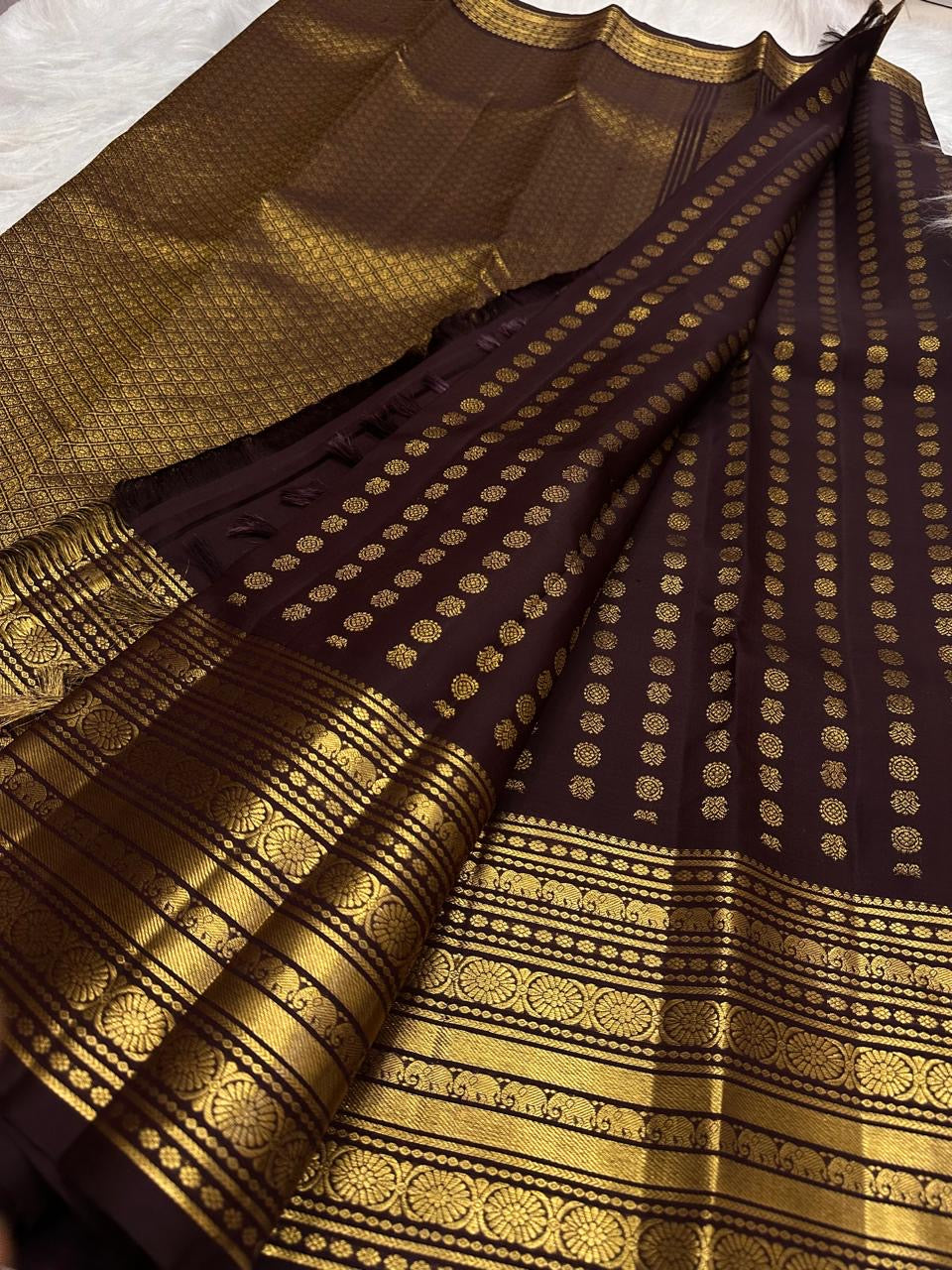 Close draped body view showing petite gold Mail buttas arranged in an orderly grid