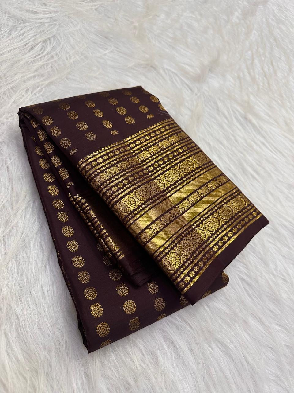 Folded body view showing handwoven Mail buttas aligned in repeated rows across dark brown silk