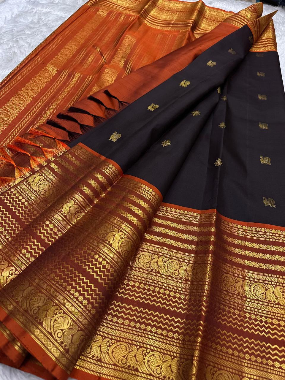 Deep espresso brown handwoven pure silk Kanjeevaram saree with Varisaipet Mayil Butta and rust orange border — Idam Living