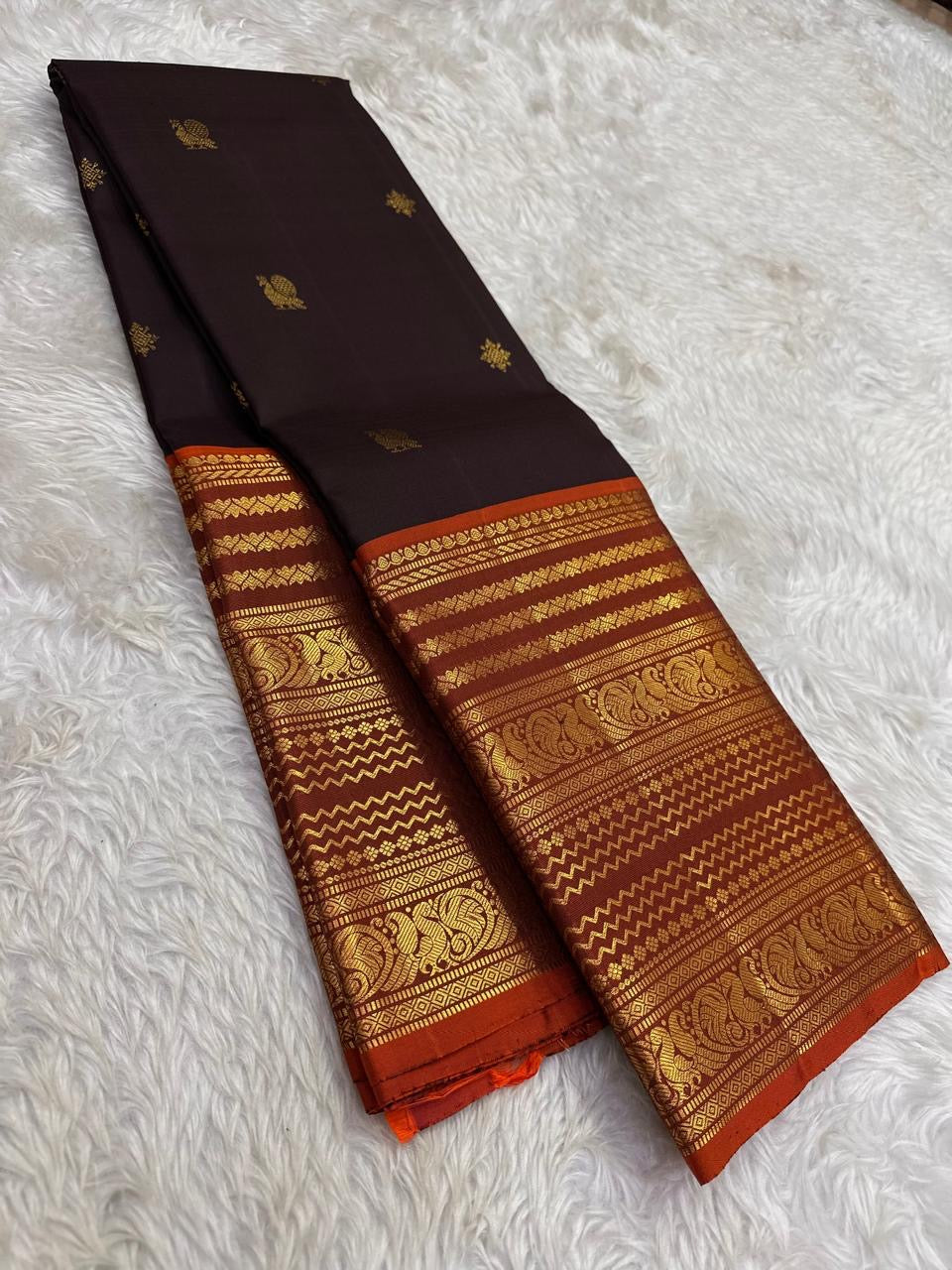 Close view of Varisaipet body showing Mayil Butta in gold zari on deep espresso brown silk