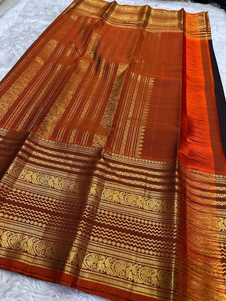 Mayil Butta peacock motif in gold zari on deep espresso brown Varisaipet body