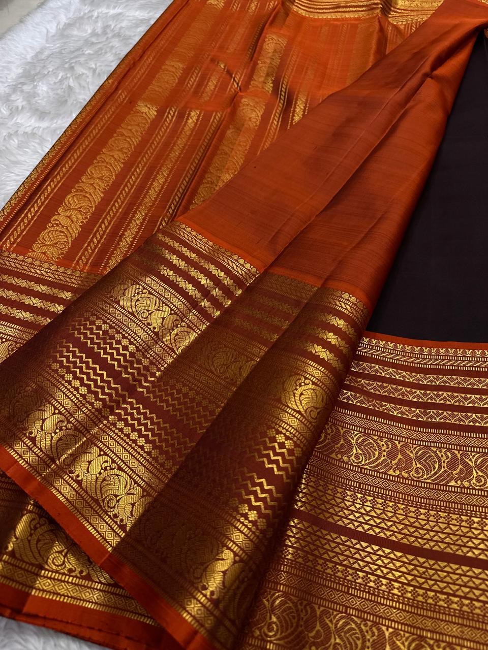 Rust orange Varisaipet pallu with red silk thread motifs on deep espresso brown saree