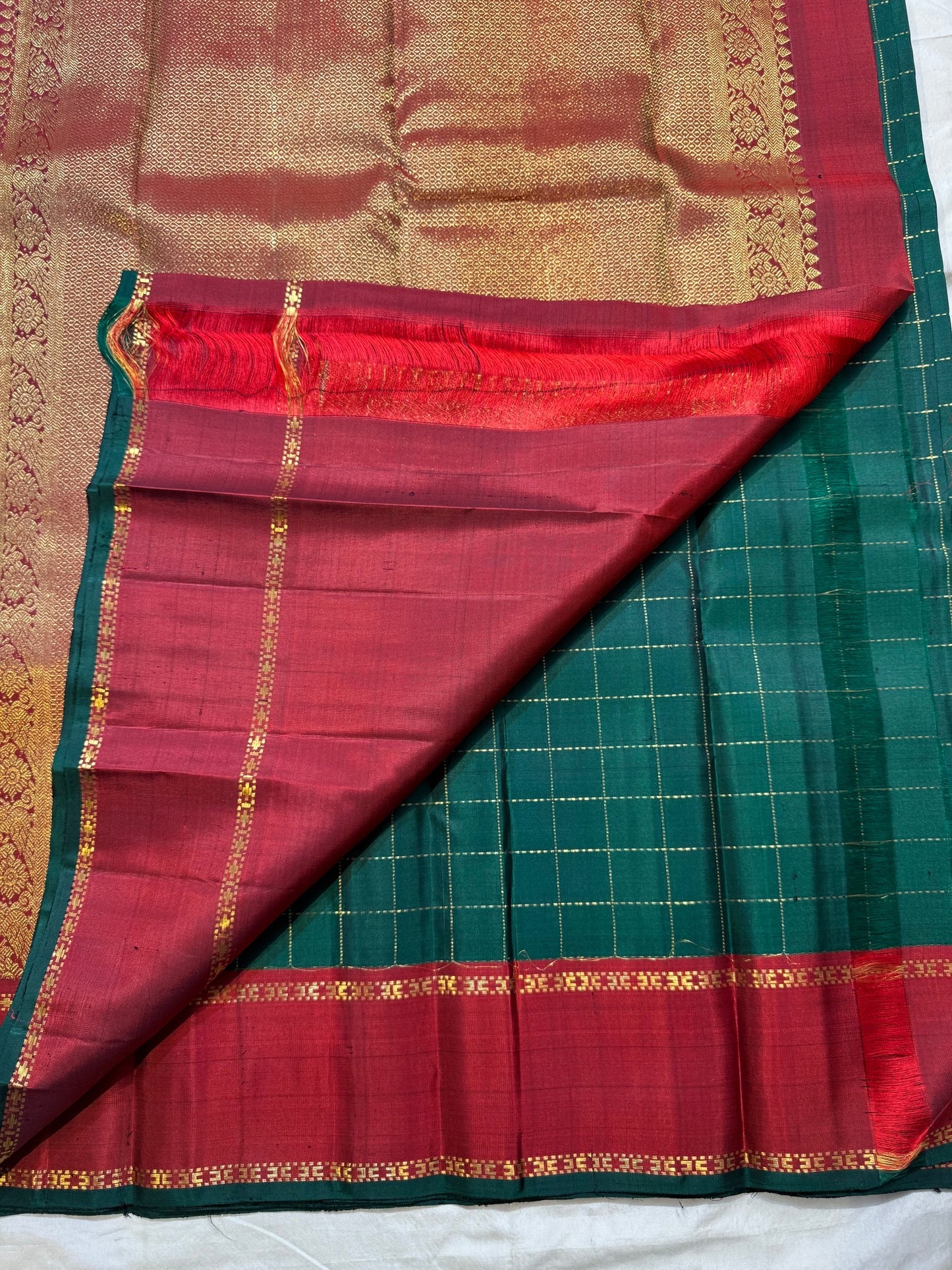 Upper border view showing the contrast between Deep Forest Green checks and Arakku Red silk