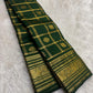 Deep Forest Green Kanjivaram silk saree showing broad handwoven gold zari peacock border