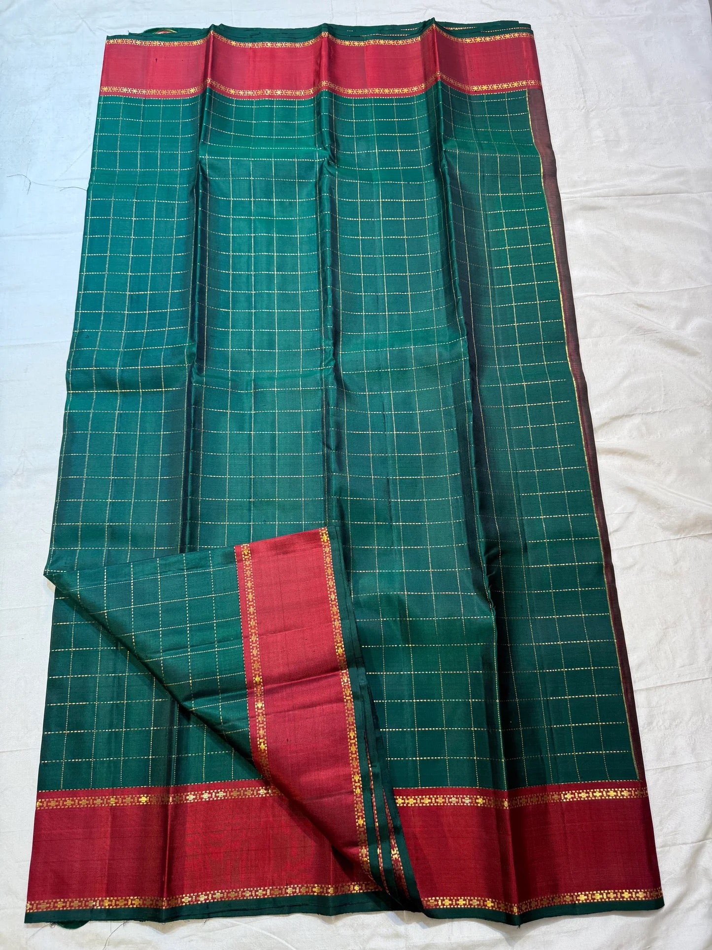 Full Deep Forest Green body showing fine dotted gold Muthu Kattam checks and red borders