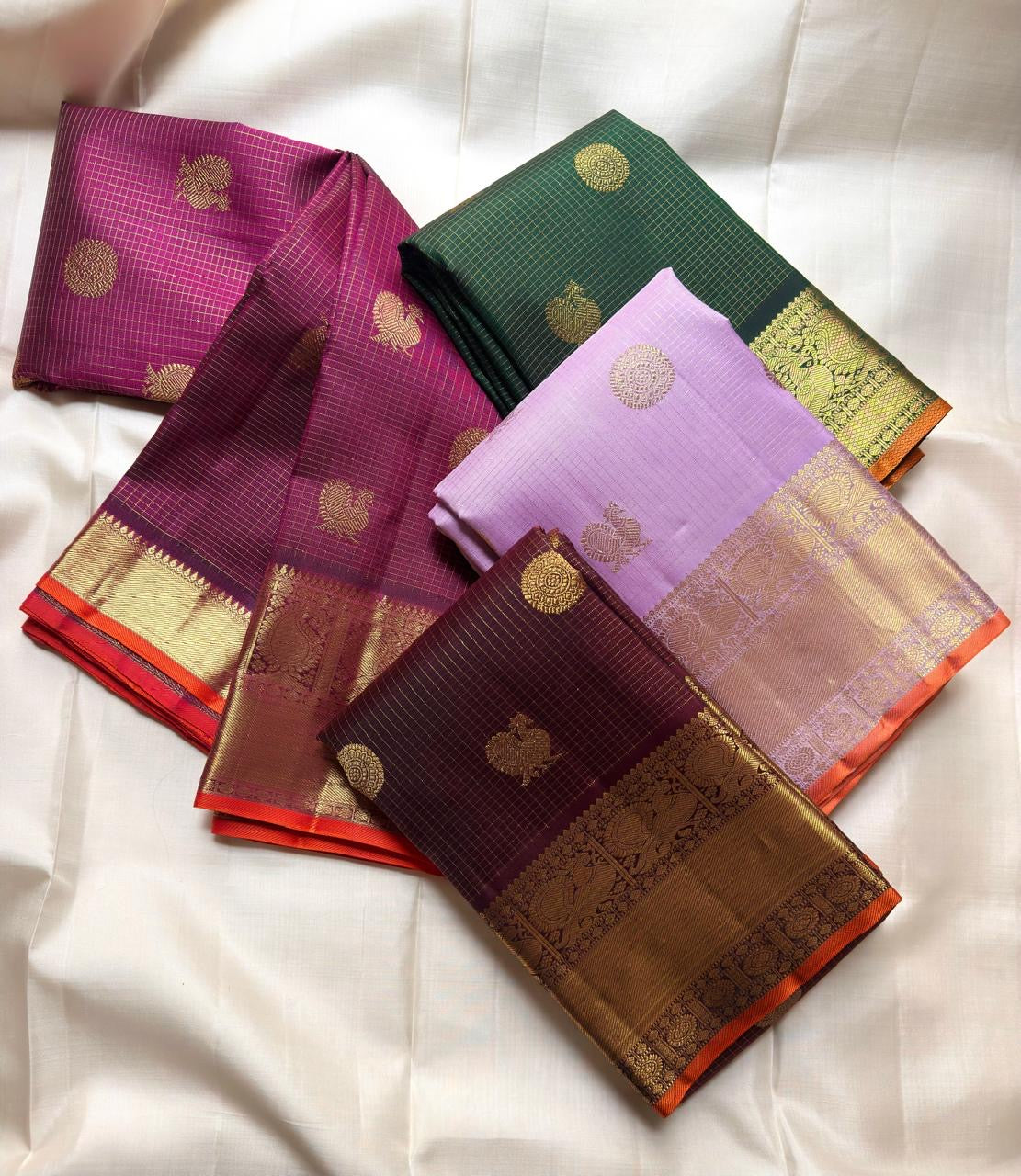 Close view of the exceptionally fine gold zari Kattam woven across the Forest Green silk.