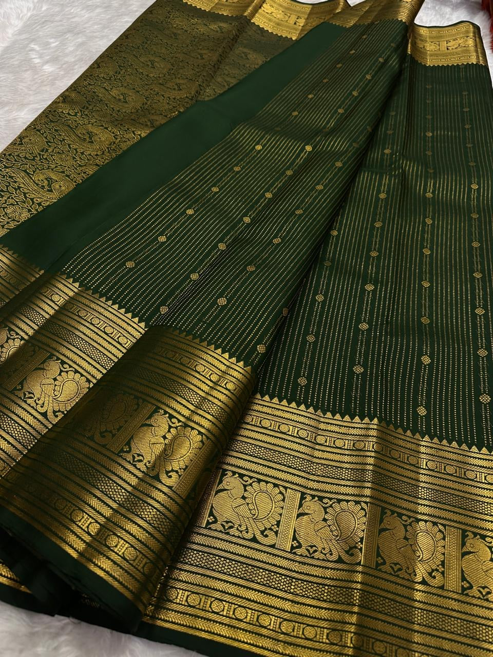 Traditional Annam motifs in framed gold zari panels on Deep Forest Green Kanchipuram silk