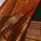Deep forest green handwoven pure silk Kanjipuram saree with Varisaipet Mayil Butta and rust orange border — Idam Living