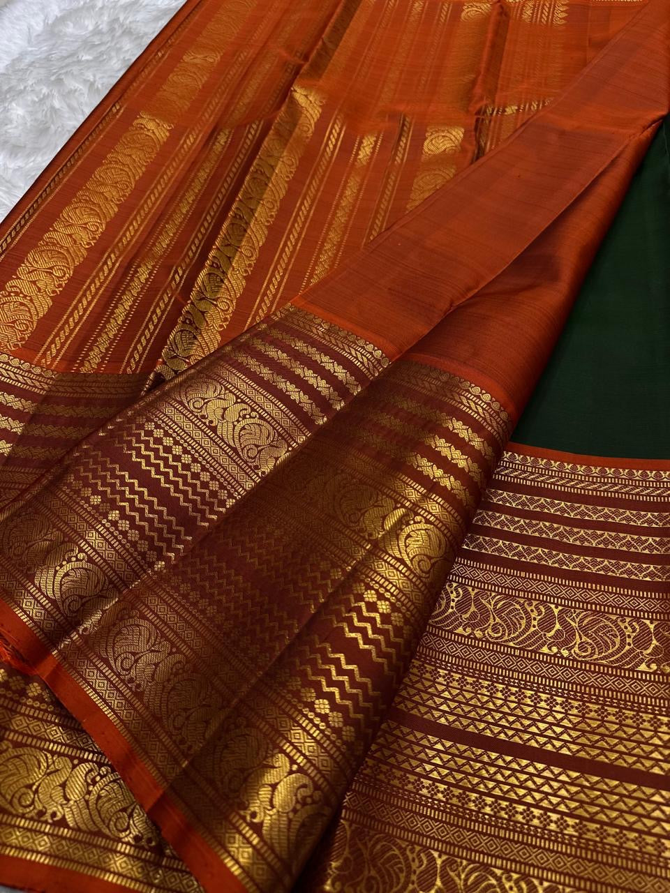Deep forest green handwoven pure silk Kanjipuram saree with Varisaipet Mayil Butta and rust orange border — Idam Living