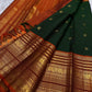 Mayil Butta peacock motif in gold zari on deep forest green Varisaipet body