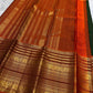 Rust orange Varisaipet border with red silk thread woven motifs on forest green Kanjipuram saree