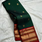 Deep green and chili red Kanchipuram silk saree draped to show full border and silk sheen — Idam Living
