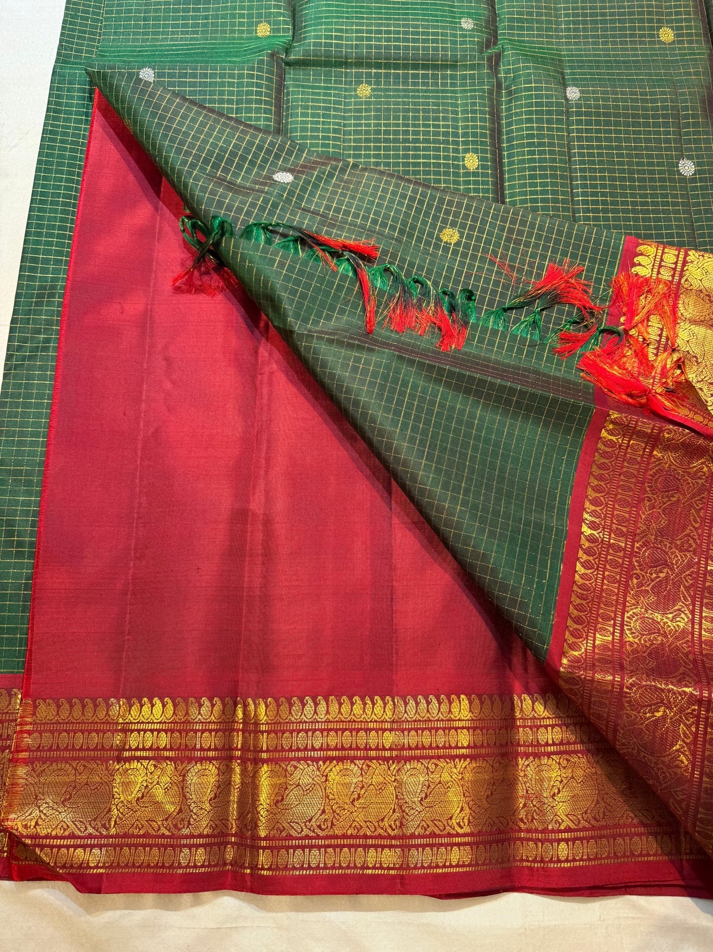 Close view of antique-gold traditional zari motifs on the Zari Kattam border.