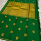 Folded deep green pure silk Kanjivaram Butta saree with traditional handwoven gold zari motifs.