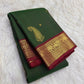 Deep Green Kanchipuram silk saree showing large reinterpreted maanga motifs balanced by smaller baby zari buttas placed across the deep green body.
