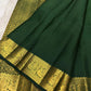 Deep green Kanchipuram Butta saree with richly detailed gold zari border