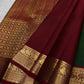 Full drape view highlighting the green body, contrast border and traditional zari workmanship.