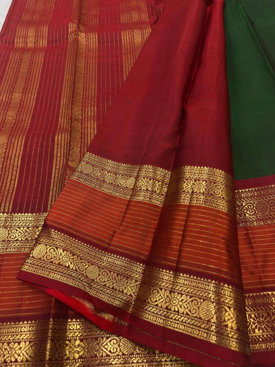 Close-up of the green silk surface and woven zari work on this Kanchipuram saree.