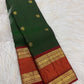 Detail of the saree border: A prominent Rettapet twin-register border in red, orange-red and gold, with Pavun motifs and stylised floral foliage arranged through the ornamental bands.