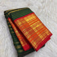 Full drape view highlighting the green body, contrast border and traditional zari workmanship.