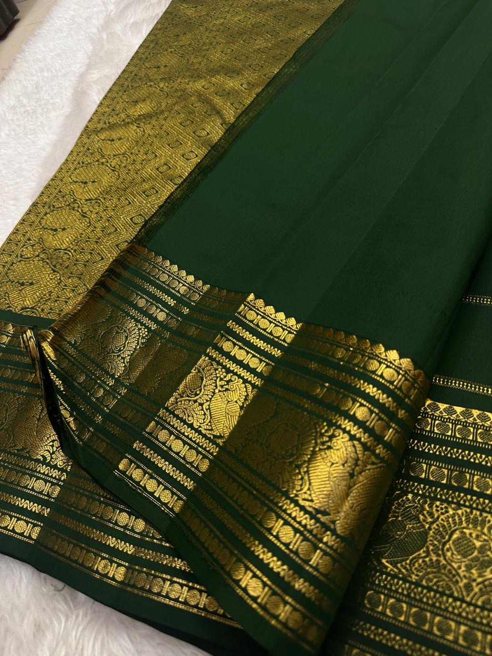 Handwoven peacock motifs in gold zari border on Deep Forest Green Kanjeevaram saree