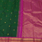 Deep green Kanjivaram saree showing its contrasting magenta border and elaborate gold zari ornamental registers.