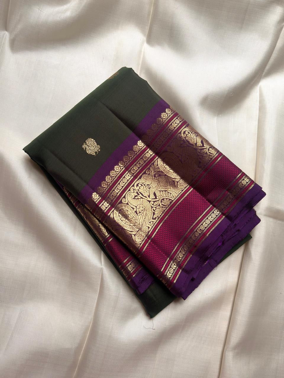 Deep Green Kanjivaram saree with ornate Royal Purple Mayil motif border