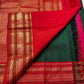 Deep green Kanjivaram silk saree with scattered gold zari motifs and traditional chili red zari border — Idam Living