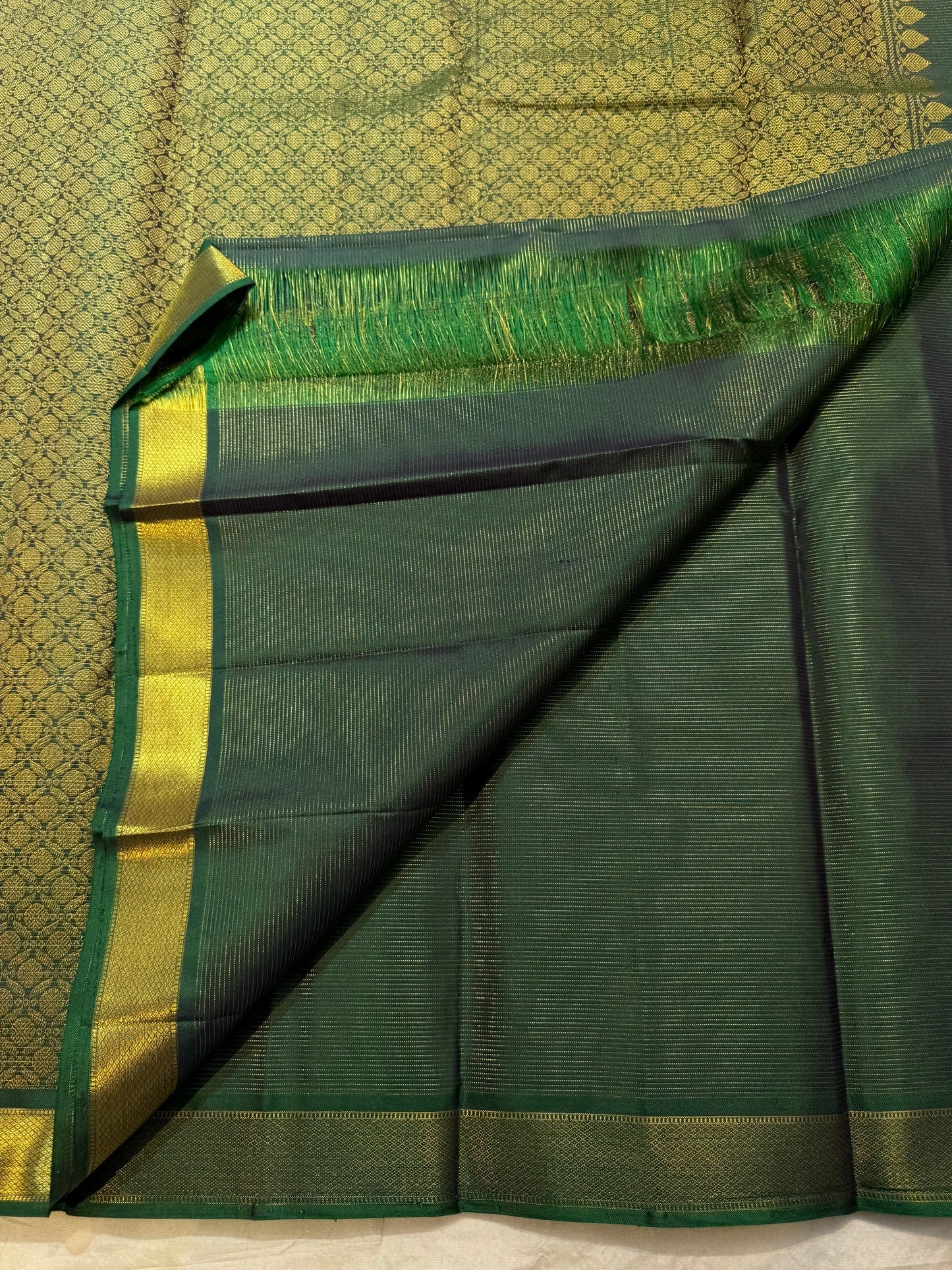 Handwoven Kili parrot zari motif on a Deep Forest Green Kanjivaram saree.