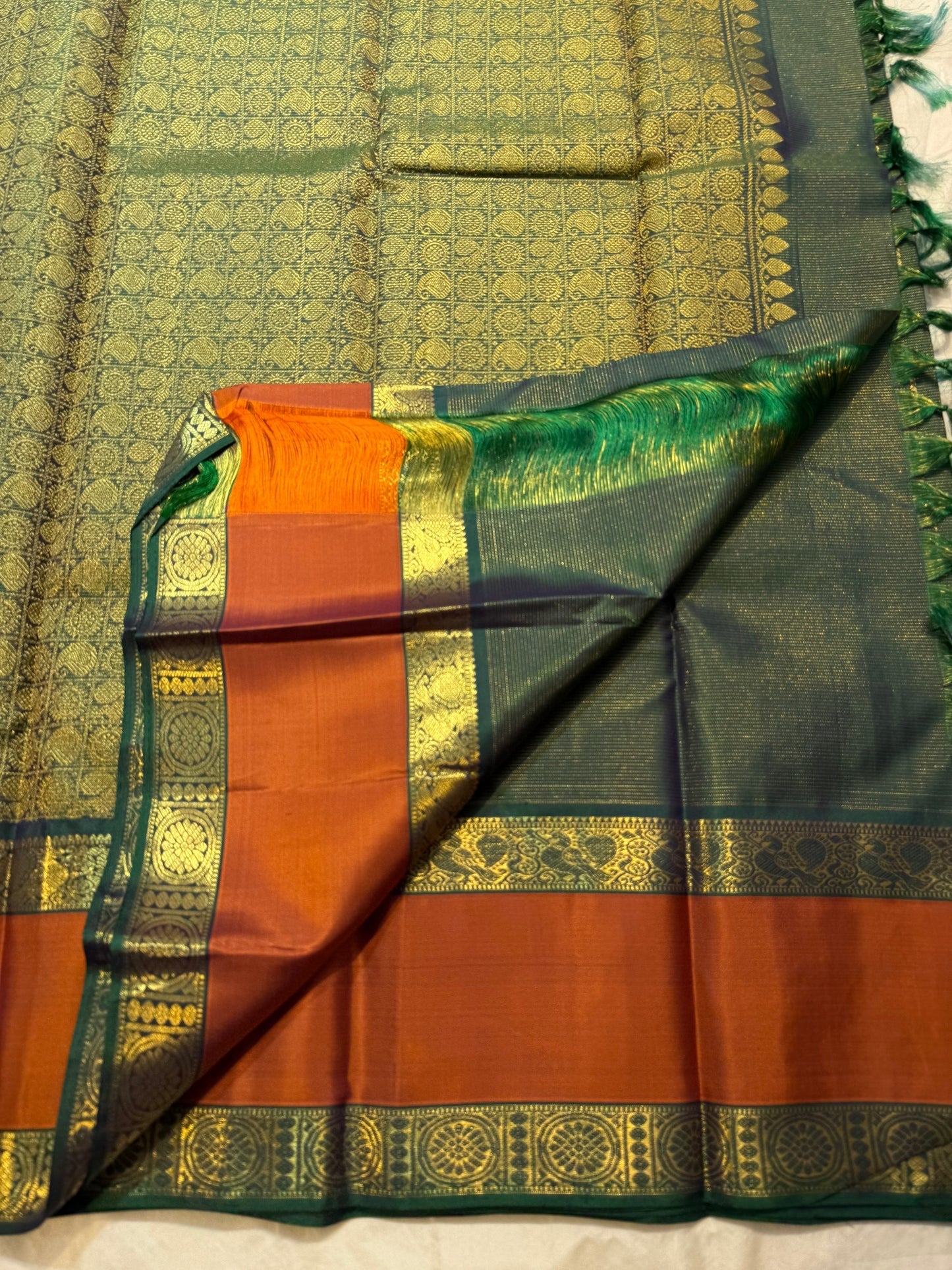 Folded view of bottle green and cinnamon terracotta vairaoosi Kanchipuram silk saree — Idam Living