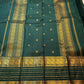 Traditional warm gold Varisaipet registers woven against deep green Kanchipuram silk.