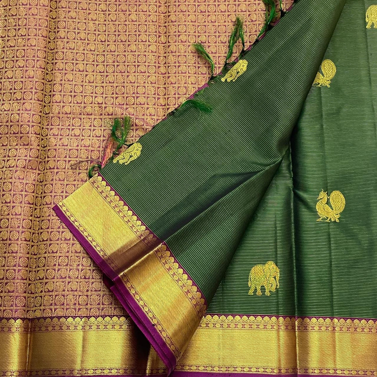 Traditional gold zari butta detail on forest-green Kanjivaram silk