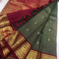 Fine Zari Kattam texture and scattered buttas on the deep Adar Pachai green silk.