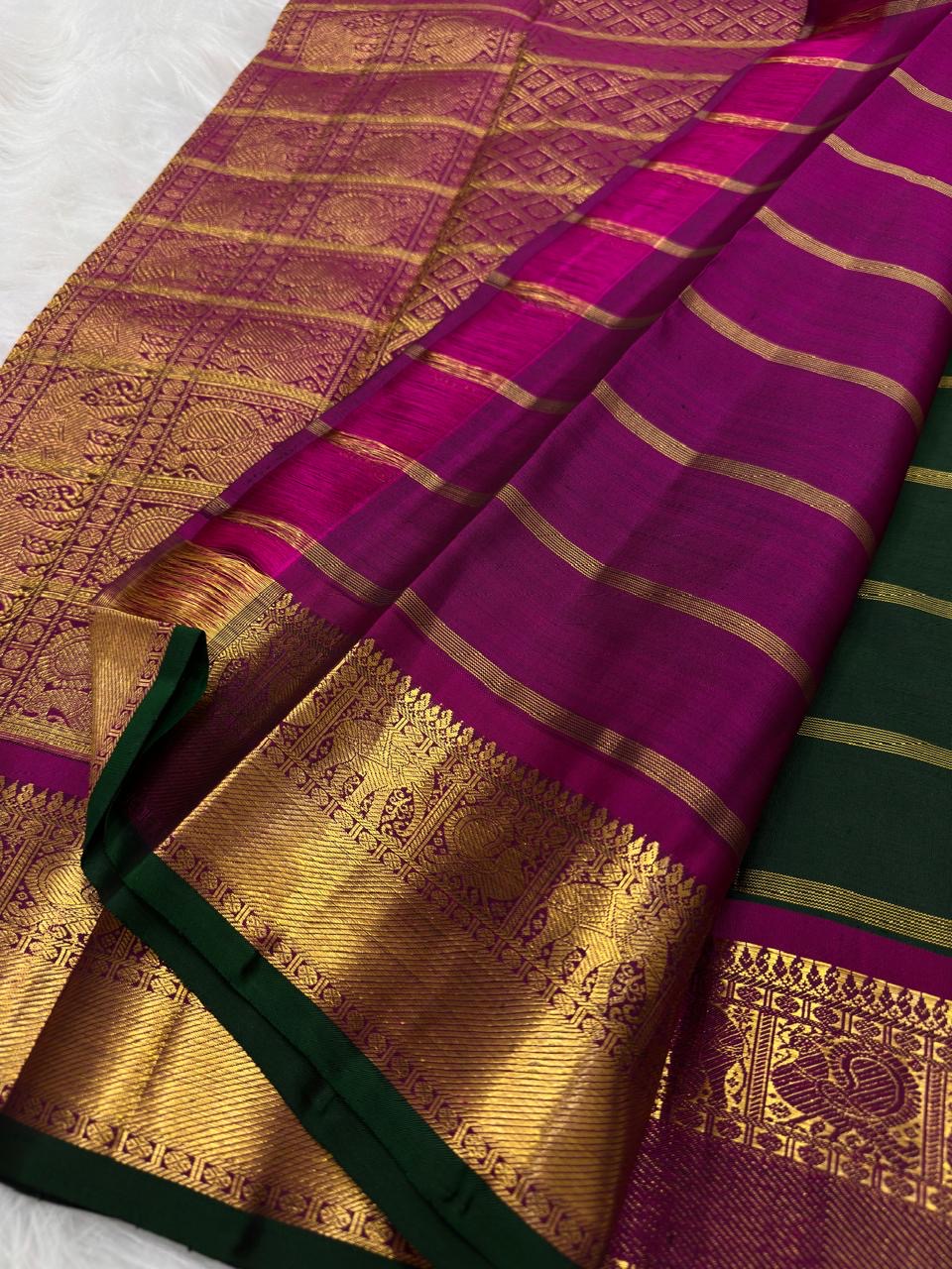 Dark green edging framing the Rani-Magenta and antique-gold zari border of the Kanchipuram saree — Idam Living