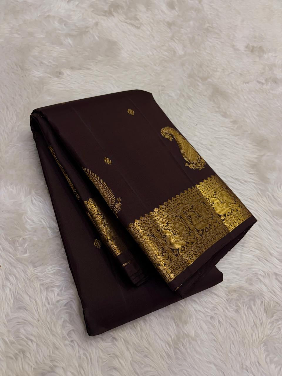 Intricate warm-gold Mayil zari border on Deep Kanchana Brown Kanjivaram saree