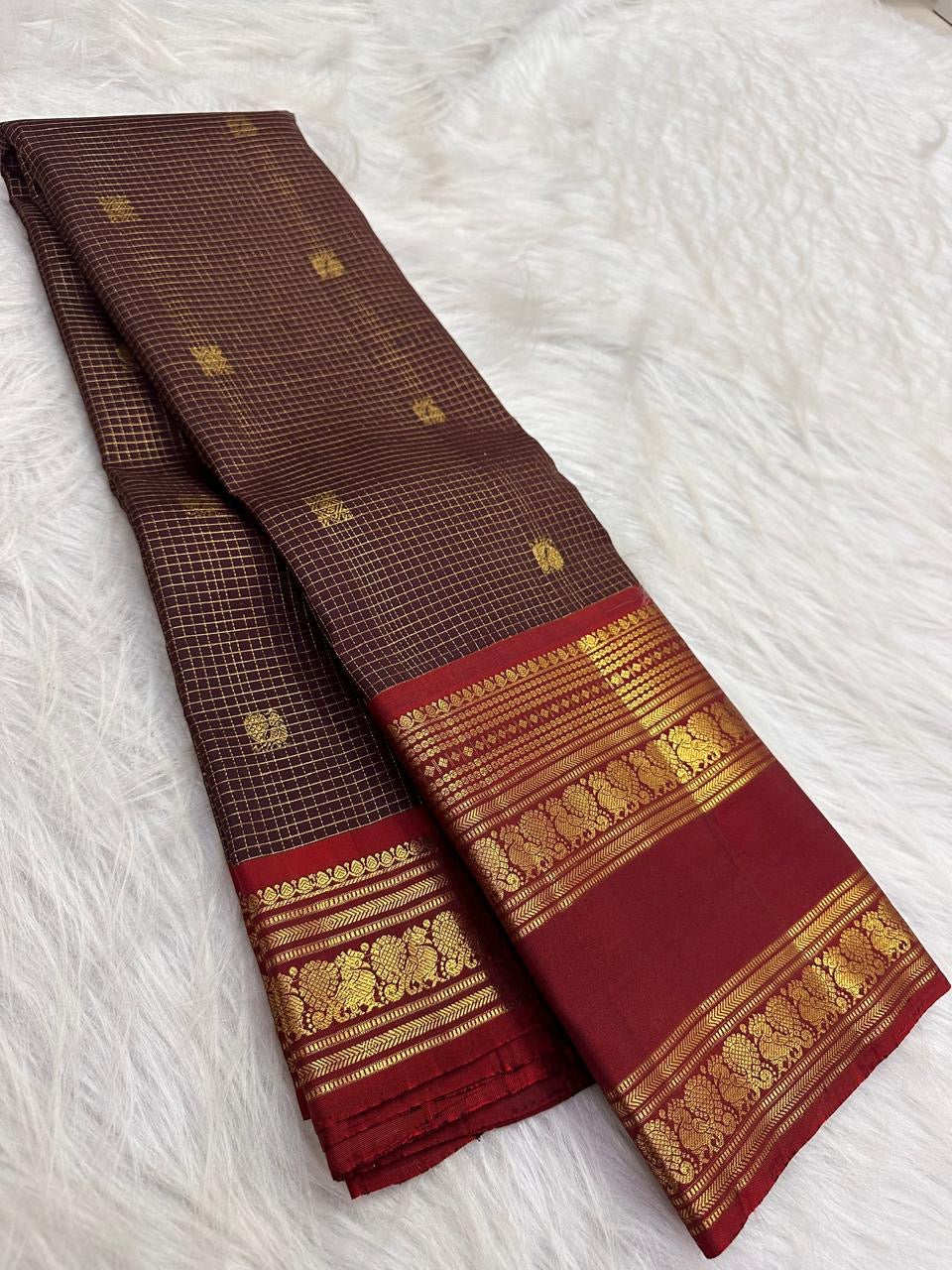 Deep Kanchana Brown pure silk Kanjivaram Zari Kattam saree with Arakku Red and antique-gold Mayil border.