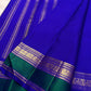 Vivid Neelam Blue and Emerald Green pure silk Kanchipuram Varisaipet saree, close-up of gold-toned woven ornament.