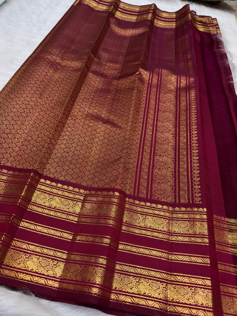Handwoven deep magenta Varisaipet saree with spaced antique-gold zari motifs.