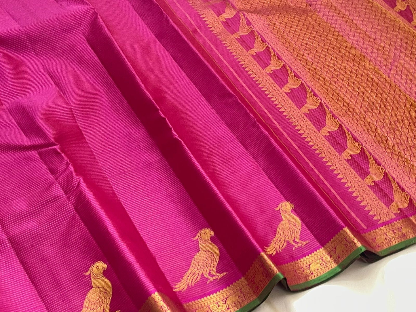 Forest green gold zari border of deep magenta Kanchi Pattu pure silk saree with classical temple motif frieze
