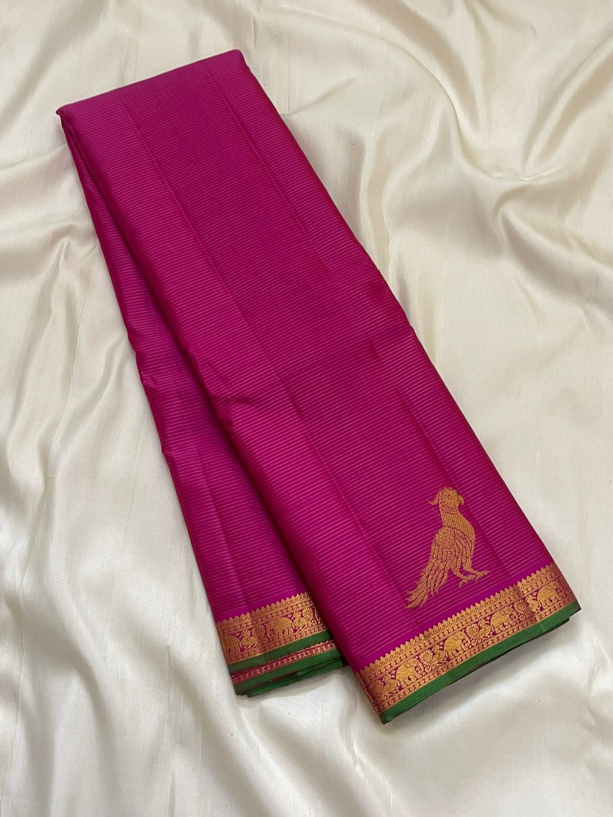 Close view of deep magenta Kanchi Pattu silk body with fine Vairaoosi zari lines running horizontally across the field